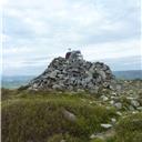 The trig point and summit cairn on Tosson Hill.